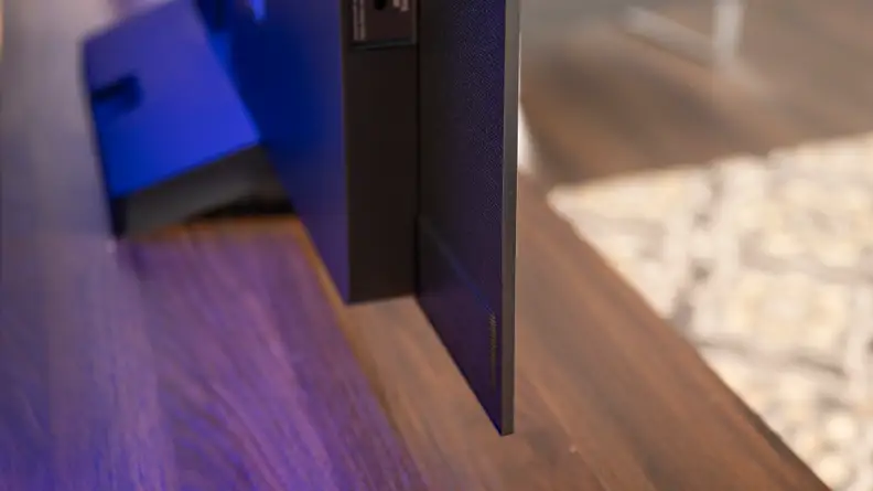 The back corner of an LG C2 OLED display sitting on a wooden table.