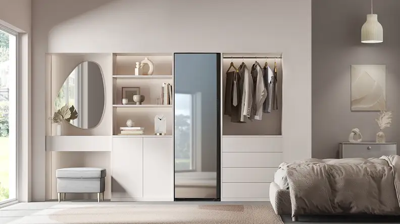 The Samsung AirDresser, installed into a modern bedroom. You can see its mirror finish reflecting light from a window.