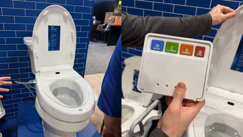 ​​Bemis Empower Clean Care cleansing toilet seat displayed open at KBIS, with a handheld remote featuring large, color-coded buttons for water, cleanser, barrier spray, and stop functions