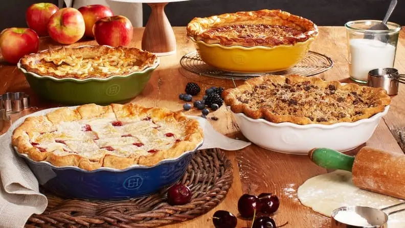 An assortment of pies sit on a dining table.