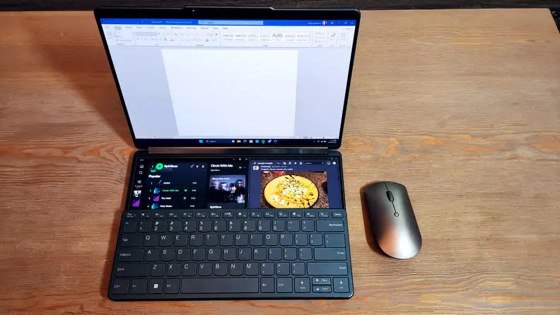 A dual-screen laptop with a keyboard attached to the lower half of the bottom display.