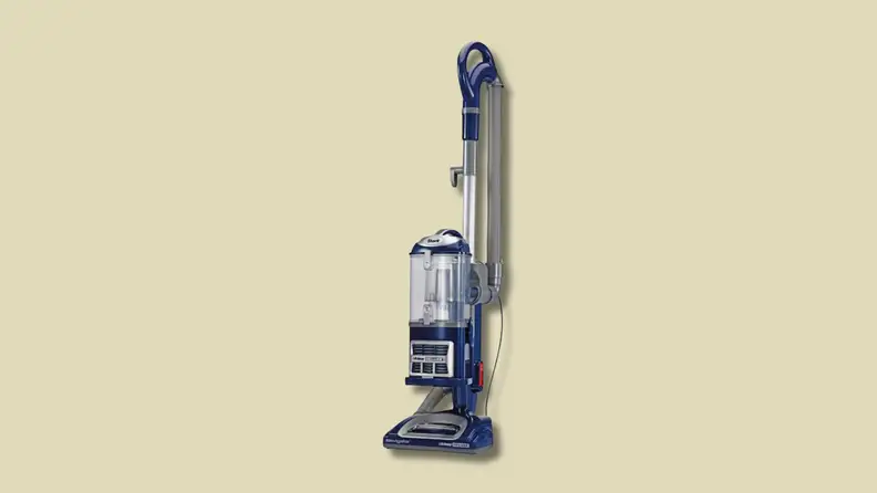 An upright vacuum cleaner on a beige background