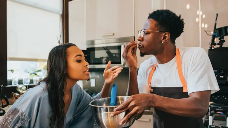 An image from the short film "Two Distant Strangers" featuring the main characters together in a kitchen.