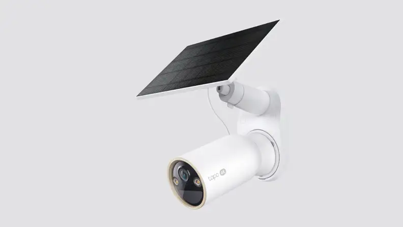 A security camera placed on a gray background
