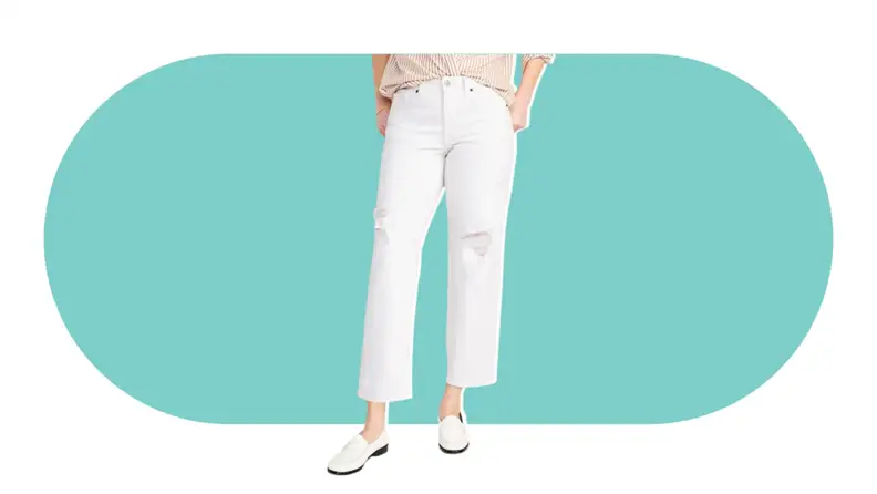 A model wearing the Old Navy High Waisted OG Loose Ripped White Jeans in white.