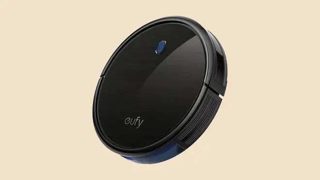 Sleek black robot vacuum against a beige background