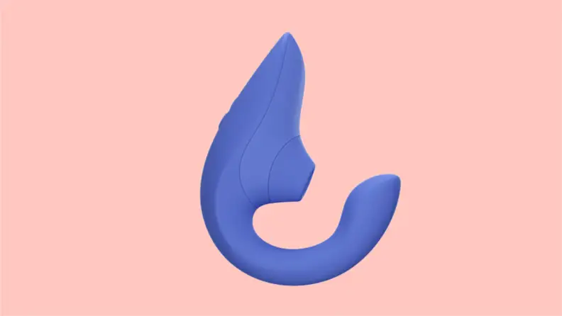 A purple Womanizer Blend vibrator in purple on a pink background.