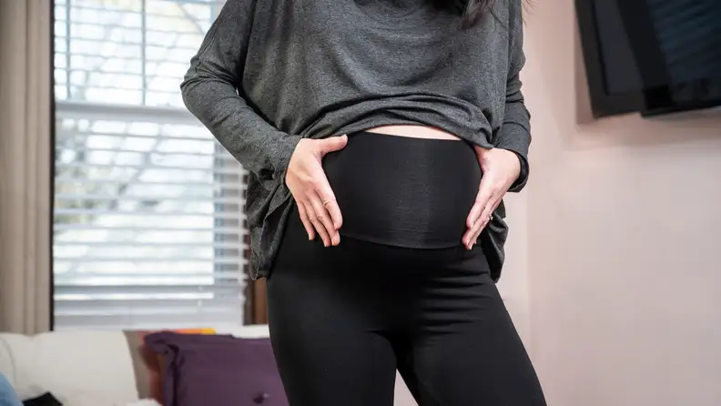 A pregnant woman wearing modal and spandex leggings.