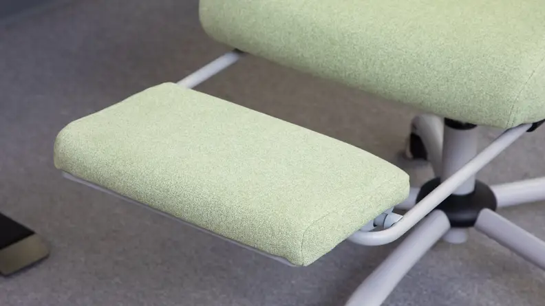 Close up shot of the padded footrest on the green EDX Reclining Office Chair.