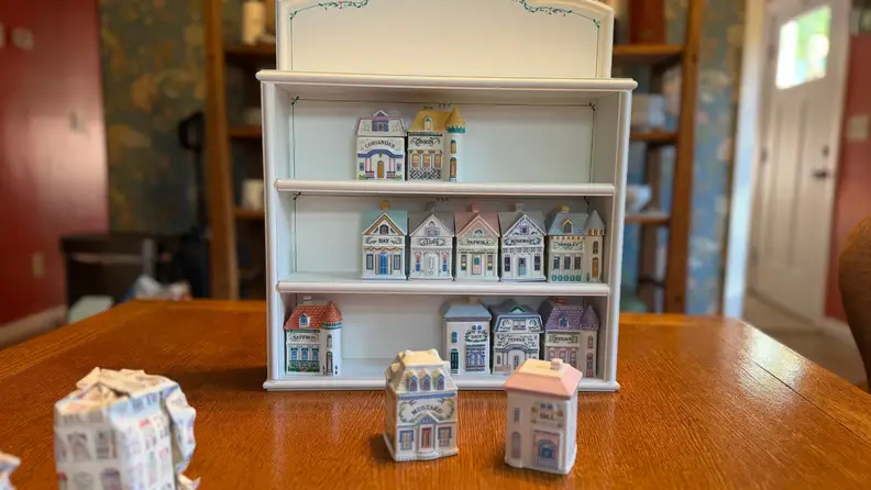 A rack and spice containers on a kitchen table