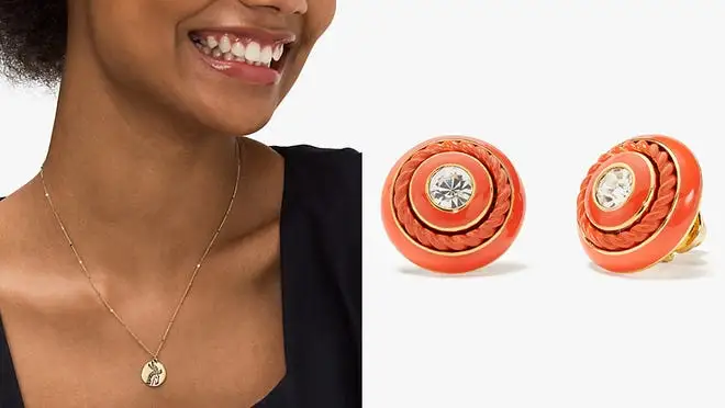 Woman wearing a gold necklace, next to orange earrings