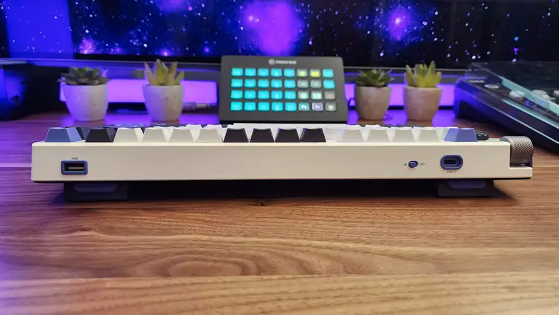The rear of the Nuphy Field75 keyboard sitting on a wooden table.