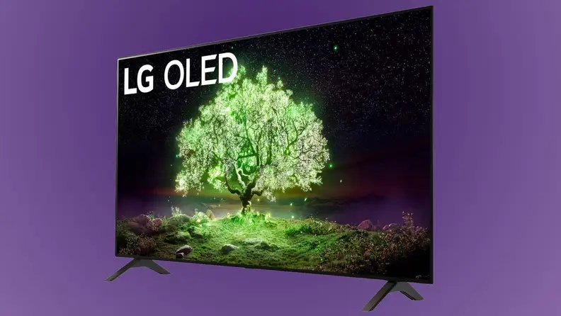 Flat screen smart TV in front of purple background.