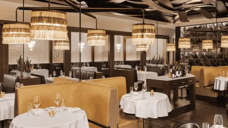 A well-decorated dining area of a steakhouse with different types of table seating