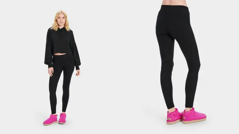 A blond model in black activewear shows off a pair of bright-pink sneakers.