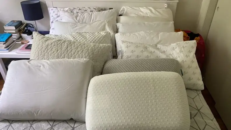a massive number of pillows on a bed