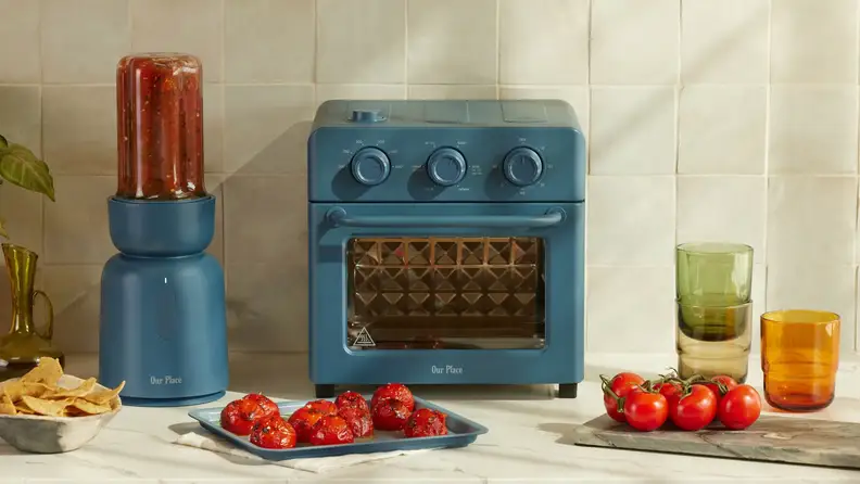 A countertop filled with Our Place products in the same blue color