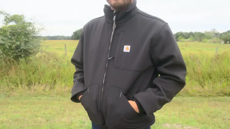 Man putting hands inside of Carhartt Detroit Jac.