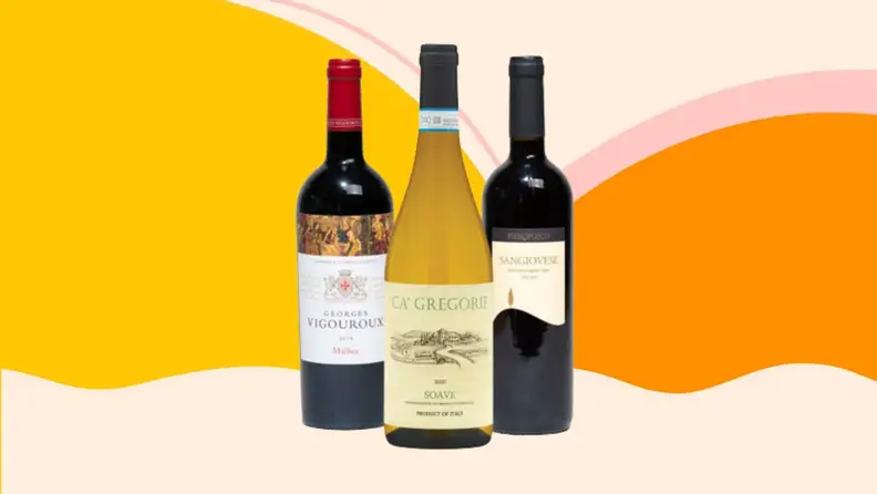 Bottles of 2018 Georges Vigouroux Hommage Malbec, a 2020 Pierofosco Sangiovese di Toscana I.G.T., and a 2019 Ca’ Gregorie Soave D.O.C. on a pink, orange, and yellow background.
