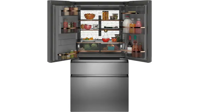 A shot of the Café CVE28DM5NBS5 French door refrigerator with its top doors open, full of groceries.