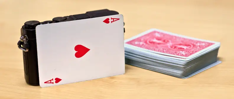 A photo of the Panasonic Lumix GM5 compared to a deck of cards.
