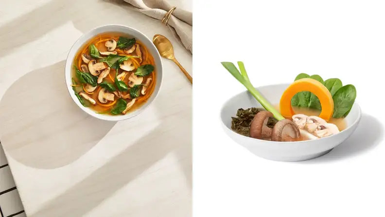 Daily Harvest soups are made with farm-fresh vegetables. The bowl in the photo has ingredients like mushrooms, spinach, and so forth; there's a spoon and a napkin beside it.