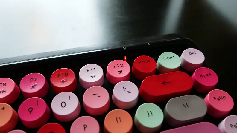 Close-up of the Ubotie Bluetooth Mechanical Keyboard battery light indicator above its keys.