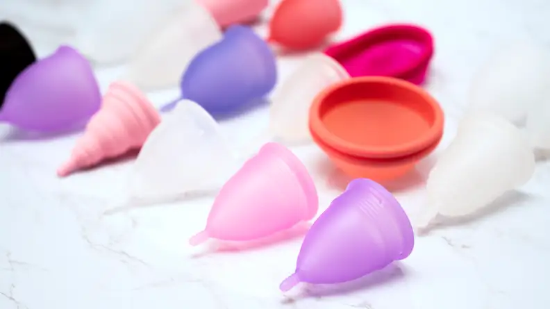 menstrual cups on white marble background