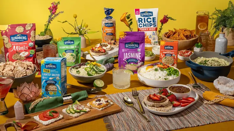 Table spread of Lundberg rice cakes, chips, and rice dishes