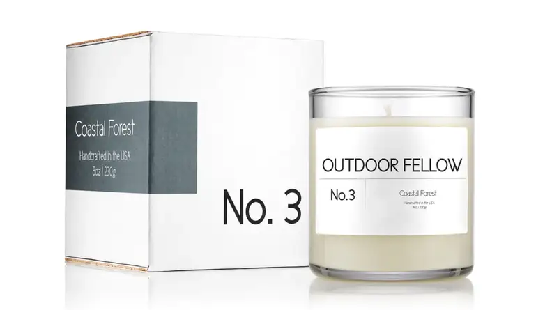 An image of the box and candle for the Coastal Forest scent from Outdoor Fellow.
