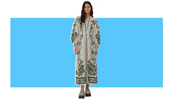A model wearing a white and blue printed maxi dress.
