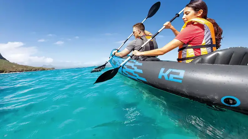Couple in an inflatable kayak on the water.