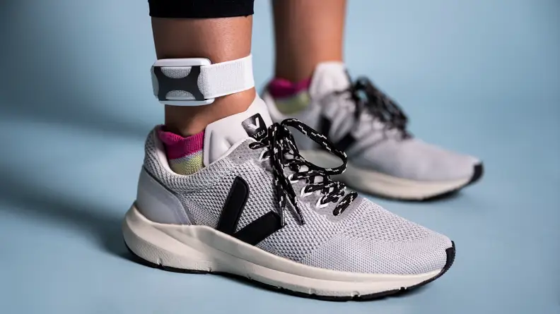 A person wears the Apollo Neuro on their ankle.
