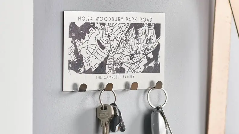 This family-sized key holder has a laser-engraved map of their new neighborhood.
