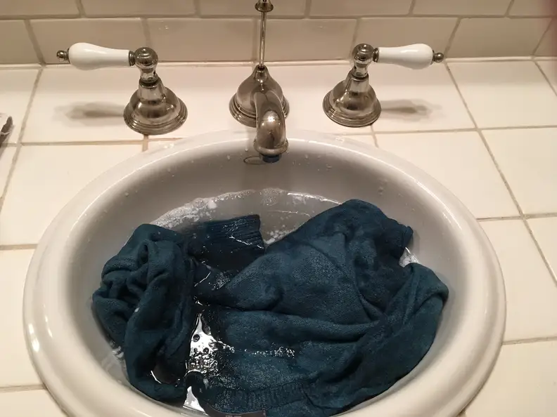 Soak sweater in lukewarm water and conditioner