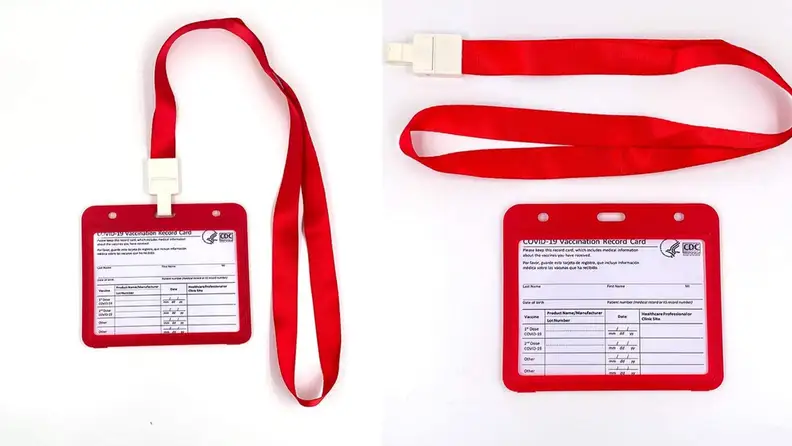 Double-sided clear badge on red lanyard.