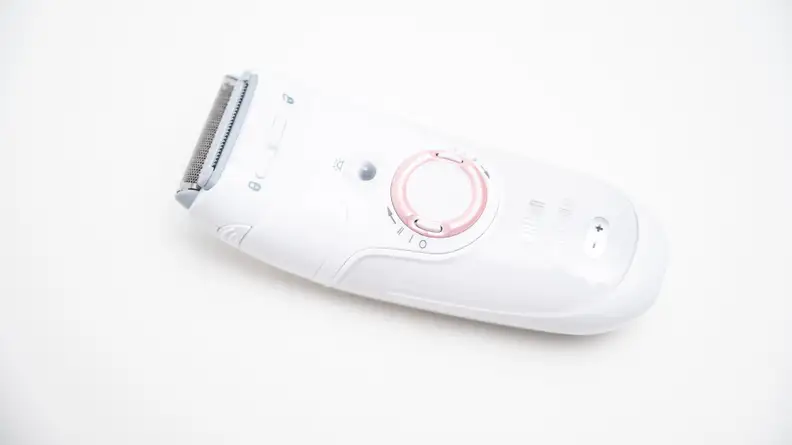The Braun Silk-Epil 9 laying on a white background.