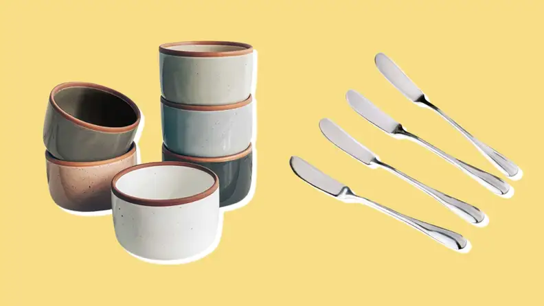 Stacked ramekins and cheese spreading knives on yellow background