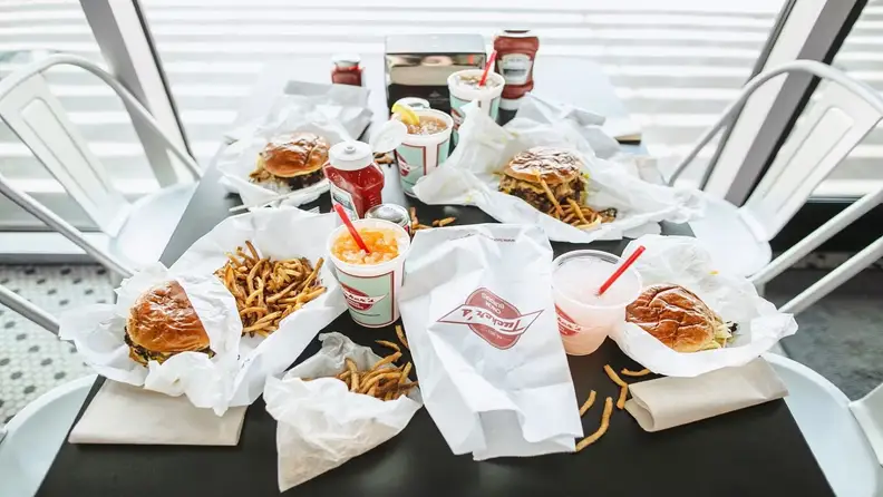 A table of burgers, fries, and drinks from Tucker's