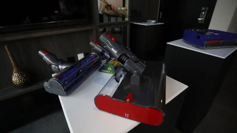 Several Dyson vacuum attachments on display.