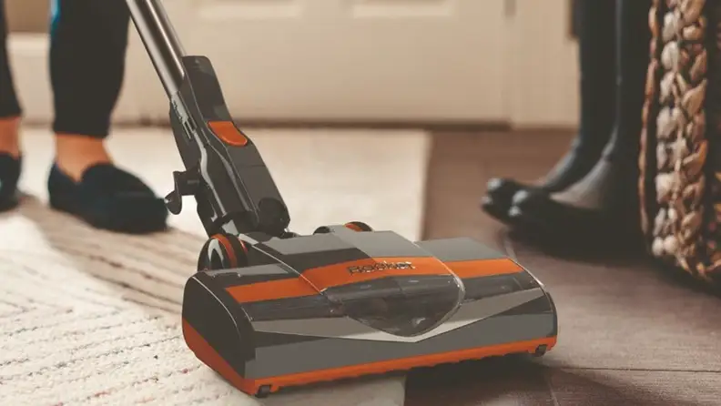 A gray-and-orange Shark Rocket stick vacuum.
