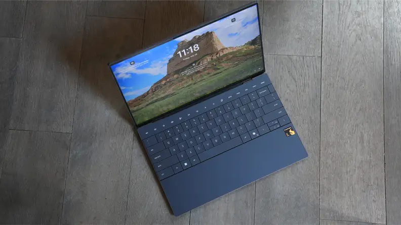 An overhead shot of the dell xps 13 opened and turned on, sitting on the floor