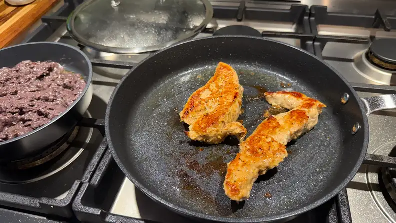 Turkey strips being fried in an Alva ceramic nonstick pan.