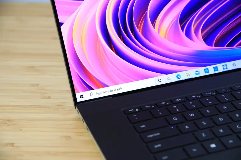 A close up of a laptop display showing off colorful wallpaper.