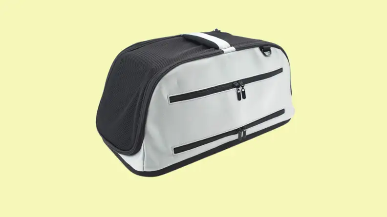 Dog carrier against yellow background