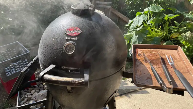 A manado grill in a sunny backyard.