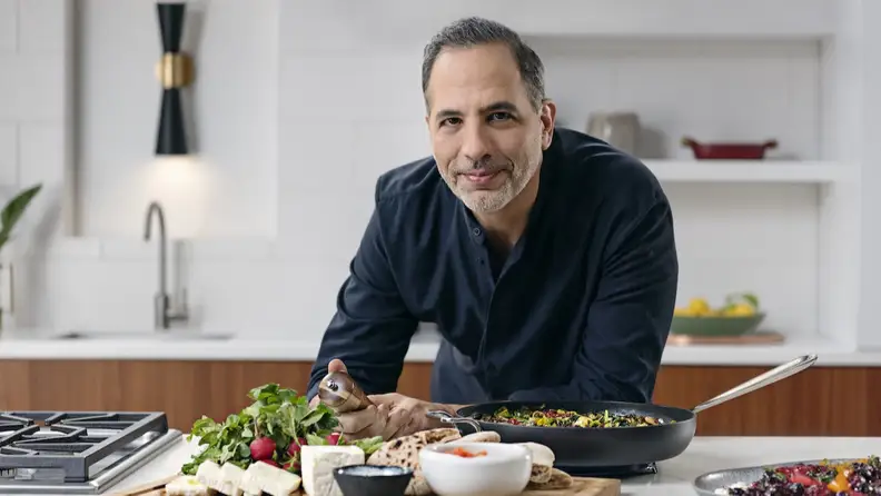 Famed chef Yotam Ottolenghi poses for a portrait in the kitchen.