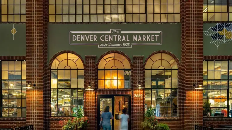 Illuminated brick facade of Denver Central Market at night