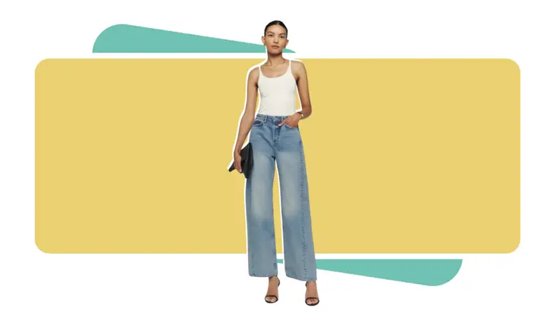 A model wearing blue jeans with a white top.