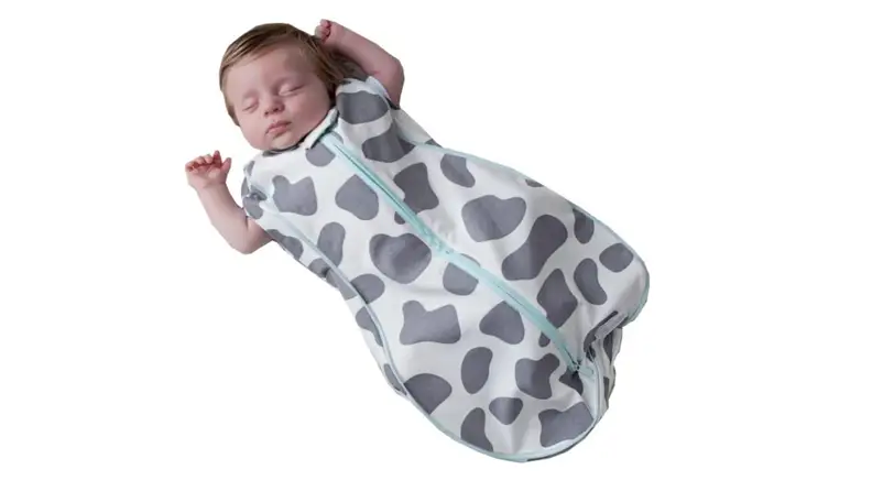 A sleeping baby in a printed sleep sack